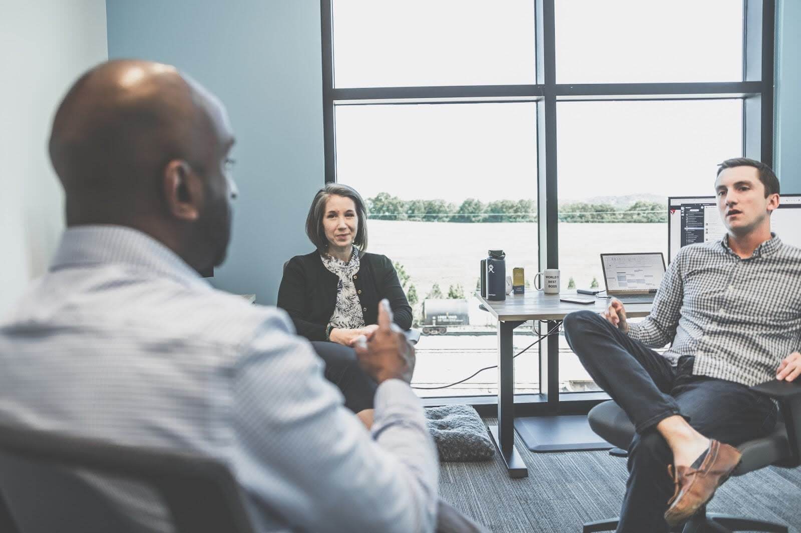 Three employees in a meeting.