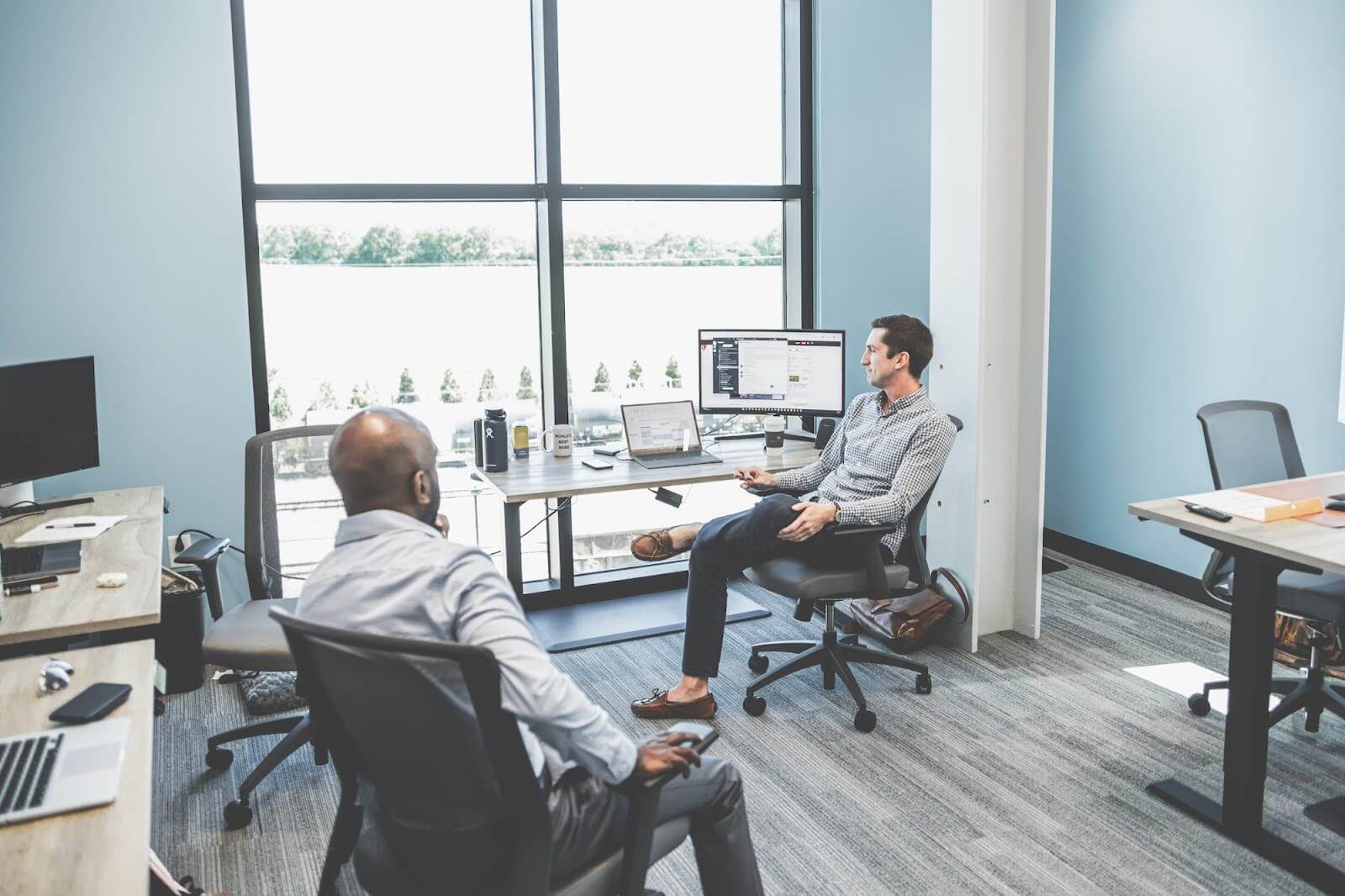 Two employees sitting in an office.