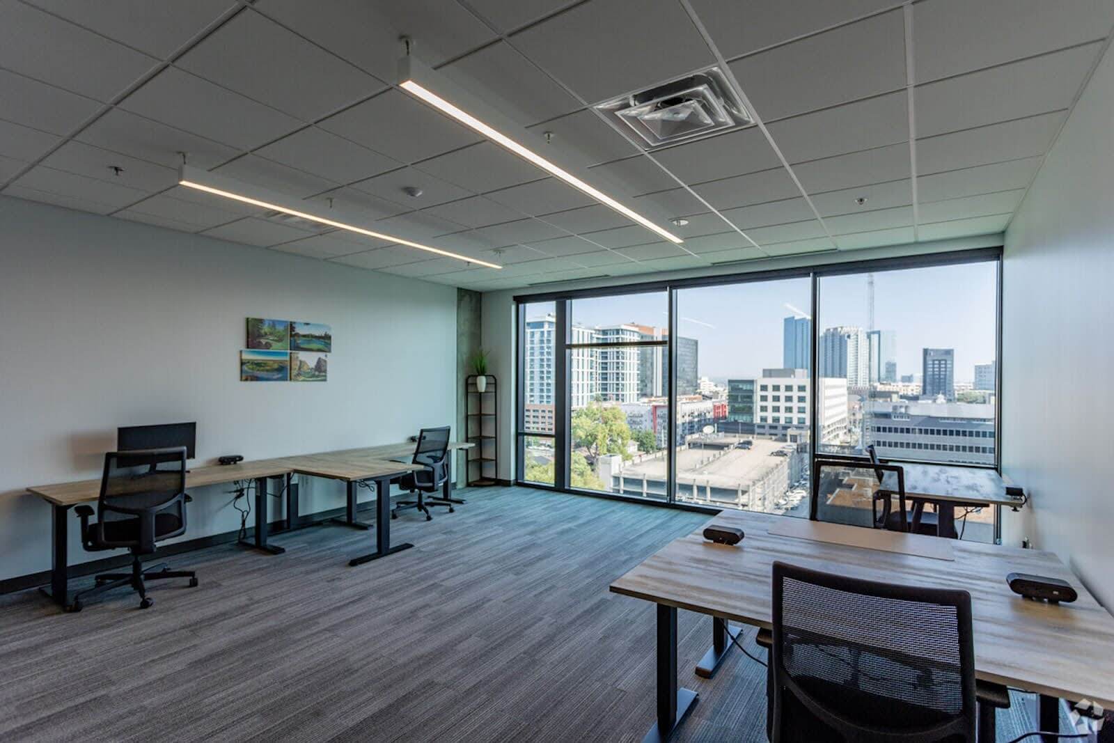 An empty office space with four desks.