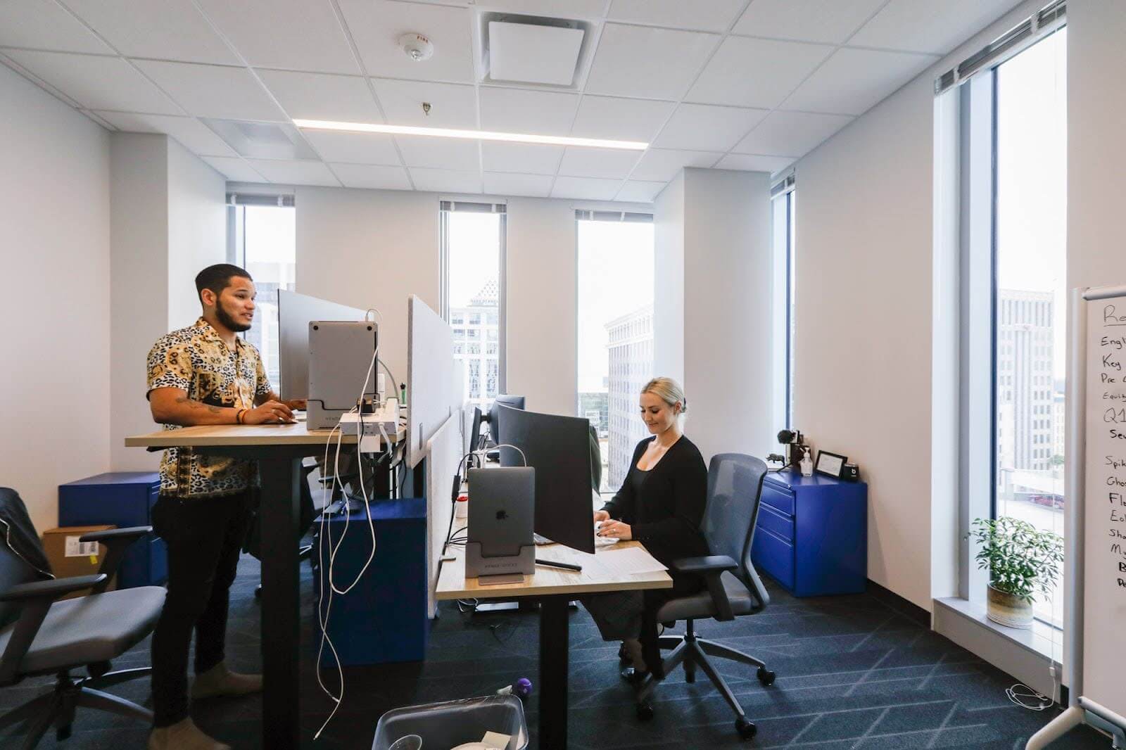 Two employees working in an office space.